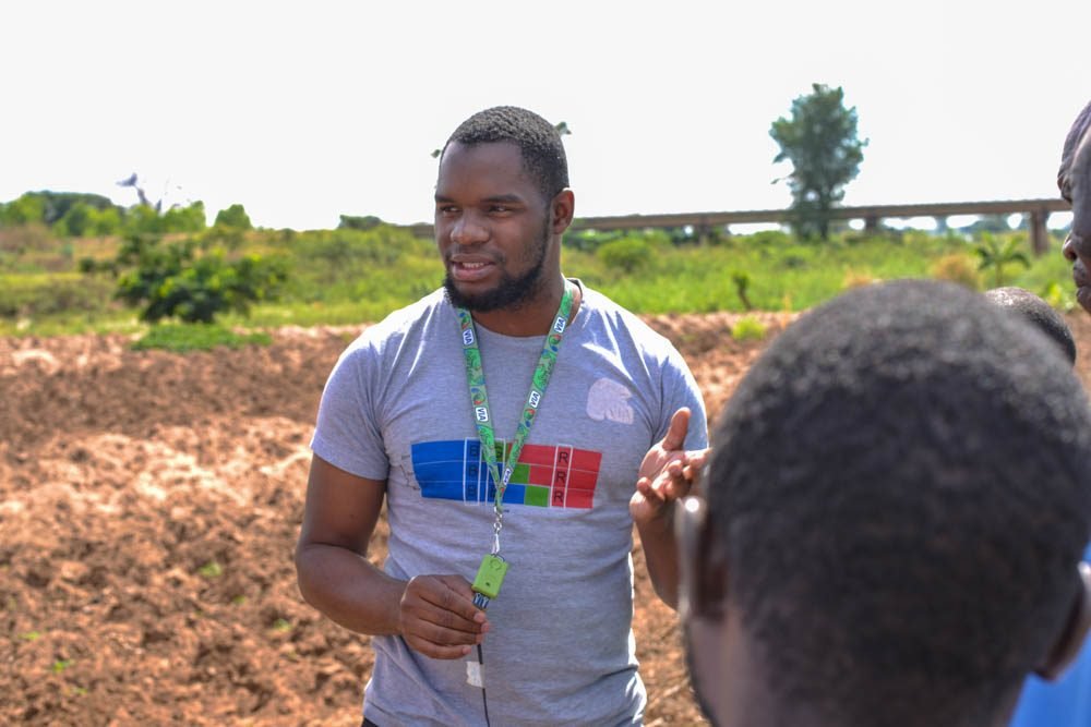 A VIA field officer talking with farmers at Katchika irrigation scheme, Malawi